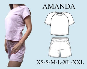 May include: A light pink pajama set, consisting of a short-sleeved top and shorts, is shown. The word "AMANDA" is above a line drawing of the pajama set. Below the drawing are the sizes: XS-S-M-L-XL-XXL.
