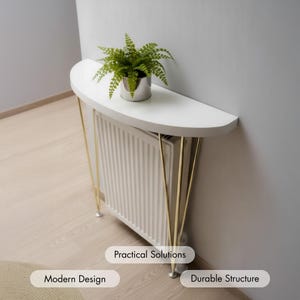 May include: A white, semi-circular console table with gold-colored legs, positioned over a radiator. A small potted plant sits on the table's surface. The design is modern, with the text "Practical Solutions" and "Durable Structure".