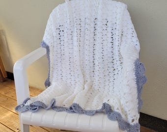 Baby blanket crocheted in iridescent white yarn with gray border