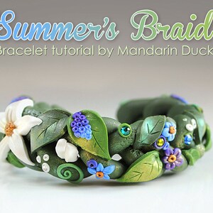 May include: A green polymer clay bracelet with a braided design, decorated with white flowers, blue and purple flowers, and green leaves. The bracelet is accented with small green and blue rhinestones. The text "Summer's Braid" and "Bracelet tutorial by Mandarin Duck" is displayed above the bracelet.