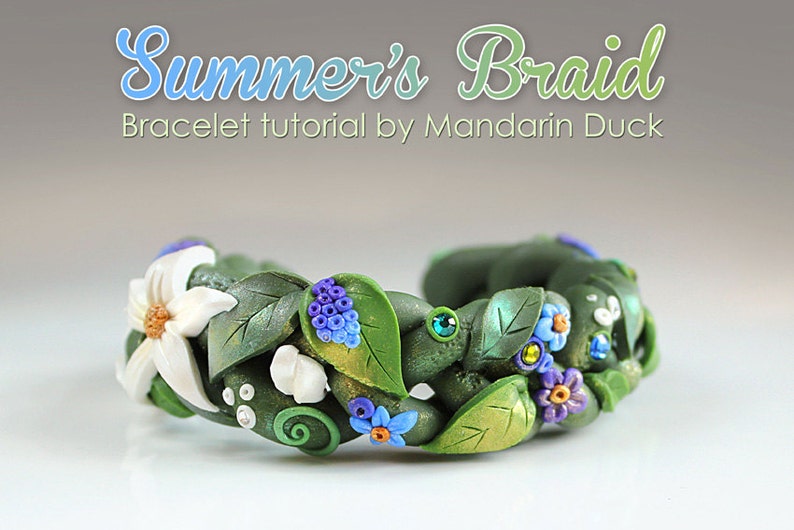 May include: A green polymer clay bracelet with a braided design, decorated with white flowers, blue and purple flowers, and green leaves. The bracelet is accented with small green and blue rhinestones. The text "Summer's Braid" and "Bracelet tutorial by Mandarin Duck" is displayed above the bracelet.