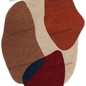 May include: A contemporary rug with an abstract pattern. It showcases irregular shapes in brown, beige, red, and navy blue. The text "Kalin Overseas" is printed on the rug. Ideal for living rooms and bedrooms, this rug adds a modern touch.