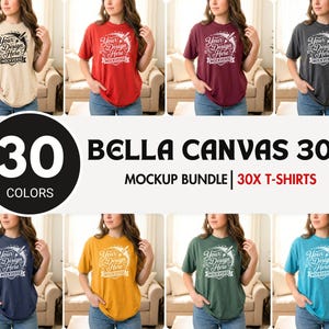 May include: A Bella Canvas 3001 mockup bundle featuring 30 colors of short-sleeve t-shirts. Each shirt displays the text Your Design Here MOCKVERSE in a circular graphic. The collection includes various solid colors worn in a studio setting.