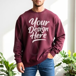 Maroon crewneck sweatshirt with long sleeves and relaxed fit, paired with blue jeans in bright natural light—made for Etsy entrepreneurs and Printify product displays.