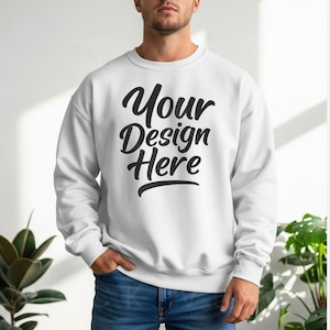 White crewneck sweatshirt with long sleeves and relaxed fit, styled with blue jeans in soft natural light—designed for POD creators and Etsy product mockups.