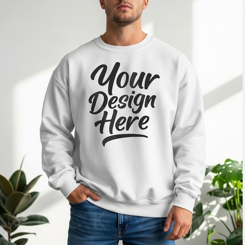 White crewneck sweatshirt with long sleeves and relaxed fit, styled with blue jeans in soft natural light—designed for POD creators and Etsy product mockups.