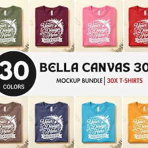 May include: A collection of Bella Canvas 3001 t-shirts in eight different colors, each featuring a white graphic print that reads Your Design Here and MOCKVERSE with an illustration of a paintbrush and paint splatter.