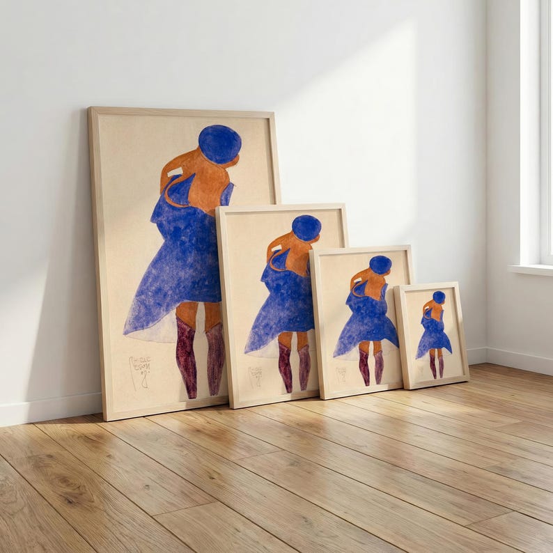 May include: A set of four framed art prints featuring a figure in a blue dress and hat, with orange skin and burgundy boots. The prints are displayed in a row, each a different size, with a light wood frame.