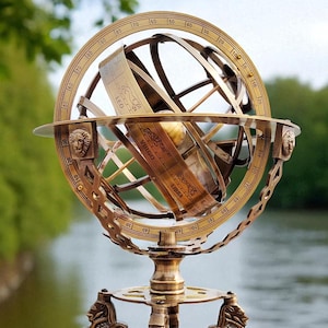 May include: A brass armillary sphere with zodiac symbols, mounted on a wooden base. The sphere has a detailed design with a globe at its center and is supported by decorative lion figures. The base is a rich, dark wood.