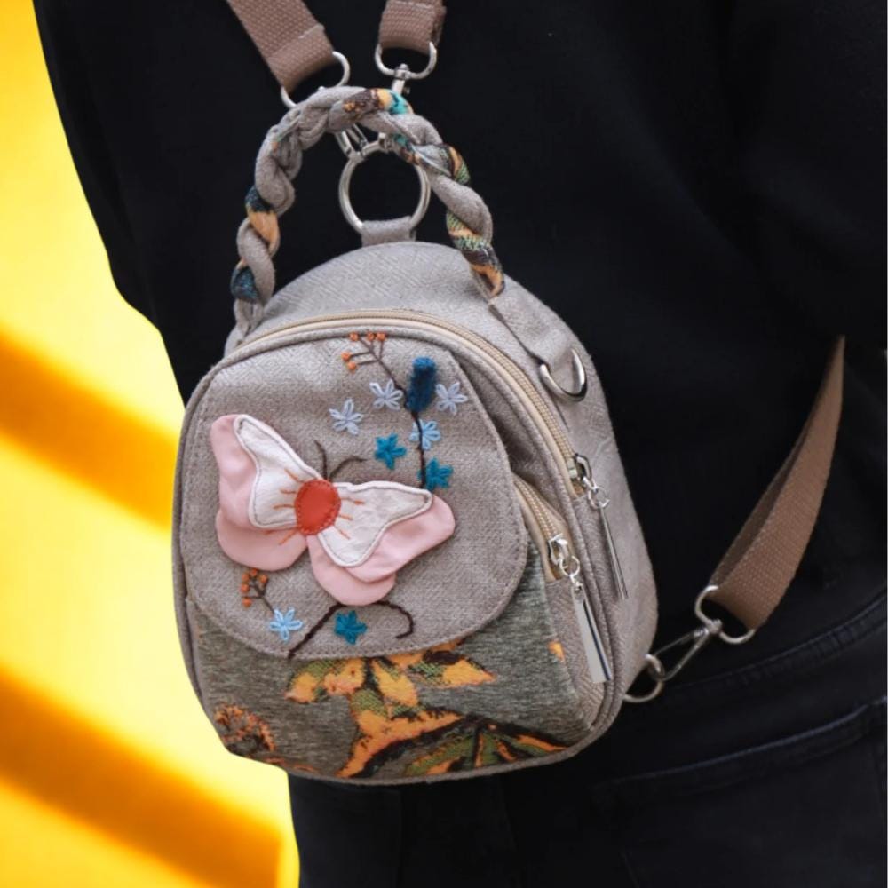 brown leather backpack with embroidered butterflies Beige GG Supreme Canvas Web Butterfly Small Day Embroidered butterfly patch BUTTERFLY LEATHER BACKPACK S |