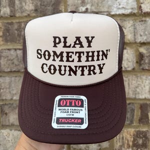 brown/tan hat with Brown text