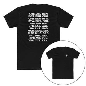 Peut inclure: T-shirt noir avec un avion blanc sur le devant et des codes d'aéroport imprimés au dos. Les codes incluent AMS, ATL, BCN, BOS, BRU, CDG, CPH, DEN, DFW, DTW, EWR, FCO, FRA, IAD, IAH, JFK, LAS, LAX, LGA, LHR, MAD, MCO, MDW, MIA, MSP, MUC, ORD, PHL, PHX, SEA, SFO, VIE, YUL, YVR, YYZ, ZRH.