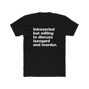 May include: Black t-shirt with white text: "Introverted but willing to discuss isengard and mordor." The shirt is made of a soft material and has a crew neck.