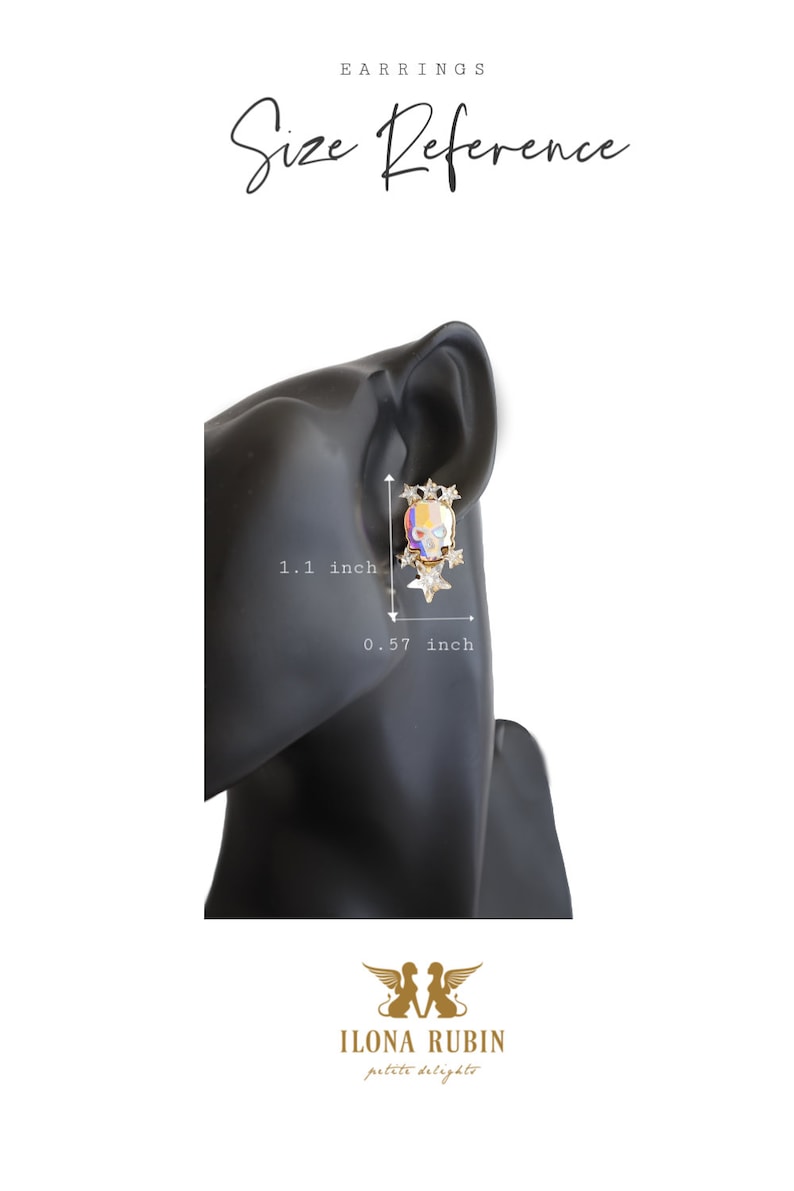 May include: A pair of gold skull earrings with colorful enamel and clear rhinestones. The earrings are 1.1 inches tall and 0.57 inches wide.