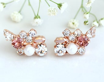 Puede incluir: Un par de pendientes de oro rosa con un racimo de cristales transparentes y rosados y una perla en el centro.