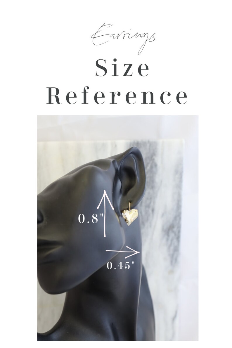 May include: Gold-colored heart-shaped earrings, 0.8 inches in height and 0.45 inches in width, displayed on a black mannequin head. The image includes the text "Earrings Size Reference".