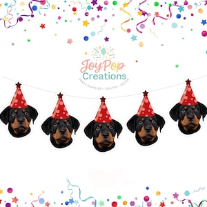 May include: A banner featuring five Rottweiler dog heads wearing red party hats with white polka dots. The banner is strung with a white string and decorated with colorful confetti and stars, perfect for a birthday party.