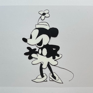 May include: Black and white cartoon character with a flower on her hat. The character is wearing a white dress, shoes, and gloves. The character has a long tail and is smiling.