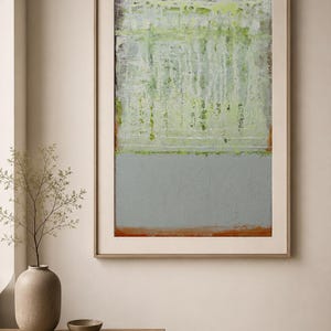 May include: Abstract art print in a wooden frame. The artwork features a two-tone design with a light green upper section and a gray lower section, separated by a thin orange line. The painting has a textured appearance.