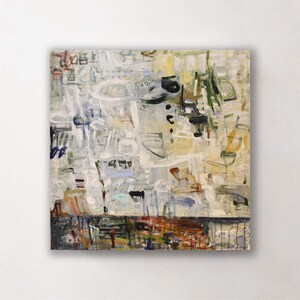 May include: Abstract painting with a square canvas. The artwork features a mix of colors, including white, beige, blue, and black, with a textured appearance. The bottom section has a darker, more colorful band.