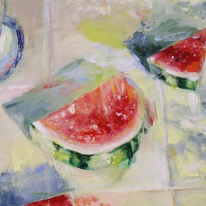 May include: An oil painting depicting two triangular slices of bright red watermelon with green rinds, positioned on a light-coloured tiled surface. A small plate with a glass of water and a round orange fruit is visible in the upper left corner.