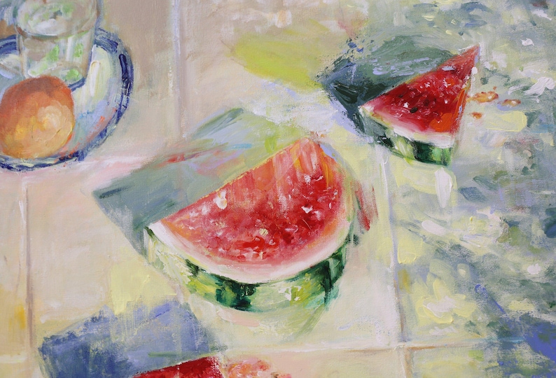 May include: An oil painting depicting two triangular slices of bright red watermelon with green rinds, positioned on a light-coloured tiled surface. A small plate with a glass of water and a round orange fruit is visible in the upper left corner.