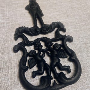 Vintage J.Z.H Cast Iron Trivet, Cherub Design, 1955
