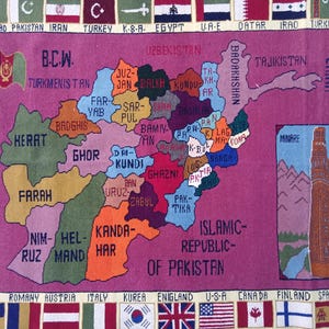 May include: A colourful rug showing a map of Afghanistan, with provinces named. The rug is mainly pink, with flags around the edges. The text "Islamic Republic of Pakistan" is also visible.