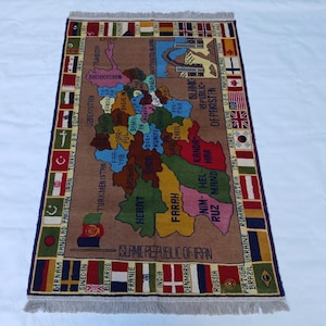 May include: A rectangular rug with a map design, showing regions and country flags. The rug has a brown background with colorful regions and borders. The text "ISLAMIC REPUBLIC OF IRAN" is visible.