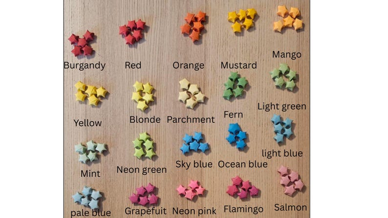 May include: A collection of colorful, star-shaped origami paper. Colors include burgundy, red, orange, mustard, mango, yellow, blonde, parchment, fern, light green, mint, neon green, sky blue, ocean blue, light blue, pale blue, grapefruit, neon pink, flamingo, and salmon.