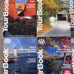 May include: Four AAA TourBook travel guides. The covers feature scenic images of Colorado, Utah, Illinois, Indiana, Ohio, Maine, New Hampshire, Vermont, New Jersey, and Pennsylvania. Each book lists attractions, lodgings, and restaurants.