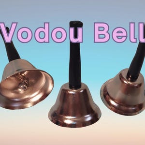 May include: Three silver-colored bells with black handles. The bells have a shiny finish and are arranged against a blue and white gradient background. The text "Vodou Bell" is displayed in pink letters.