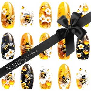 May include: A collection of nail art designs featuring bees, honeycombs, and flowers. The designs are on a variety of nail shapes and colors, including yellow, black, and clear. A black ribbon with the text "NAIL Design Mania" is across the image.