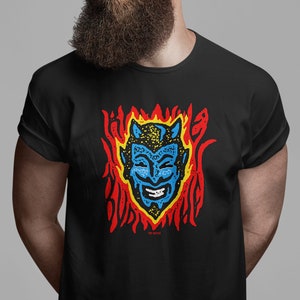 May include: Black t-shirt with a blue and yellow cartoon devil face in flames. The text "Too Bitter" is below the image.