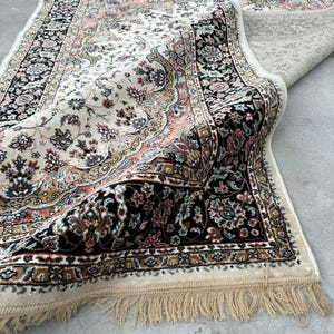 Close-up of silk wool rug fibers highlighting premium craftsmanship, intricate pattern, and soft texture