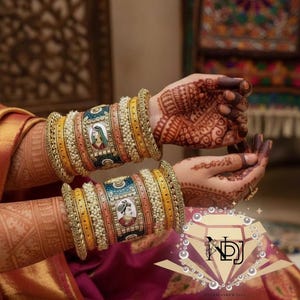 May include: Close-up of two wrists adorned with ornate, colorful bangles. The bangles feature a mix of yellow, blue, and pink hues, accented with pearls and painted portraits. The hands are decorated with intricate henna designs.