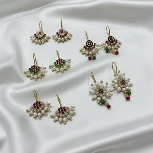 May include: A set of three ceramic mugs with a speckled, matte finish. The mugs are in shades of cream, light gray, and dark gray. Each mug has a simple, minimalist design, perfect for coffee or tea.