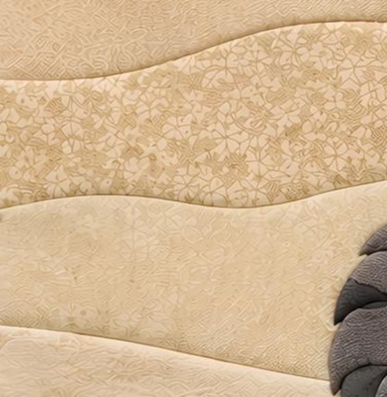May include: A textured beige surface featuring wavy horizontal bands with intricate floral and geometric patterns embossed into the material. A portion of a dark grey, layered, fan-shaped element is visible on the lower right side of the frame.