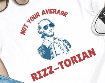 May include: White t-shirt with a graphic of George Washington wearing sunglasses, with the text "NOT YOUR AVERAGE RIZZ-TORIAN" in red. Sunglasses, a bracelet, jeans, and black sneakers are also visible.