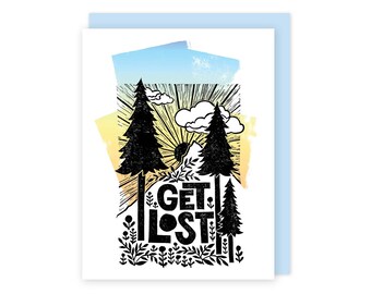 May include: Greeting card with a nature-themed design. The card features black silhouettes of pine trees, sun rays, clouds, and the words "GET LOST" in bold letters. The background has a watercolor effect with blue, yellow, and white hues.