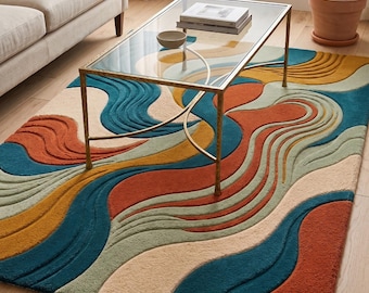 May include: A rectangular area rug featuring a textured, multi-colored pattern of flowing, wavy lines in shades of deep teal, burnt orange, mustard yellow, and cream. The rug has a high-low pile construction that creates a three-dimensional effect.