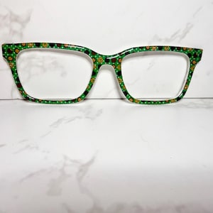 May include: Green and gold patterned eyeglasses with a clear lens.