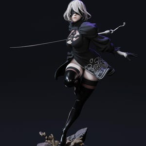 May include: A detailed figurine of a female character in a black dress with white accents, black gloves, and thigh-high boots. The character has short white hair, a blindfold, and is holding a sword. The figure is posed on a rocky base against a dark background.