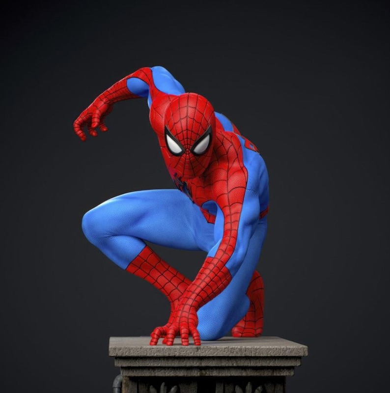 May include: A red and blue Spider-Man figurine in a crouching pose. The figure is on a stone pedestal against a dark background. The costume features a web pattern on the red areas and white eye lenses.