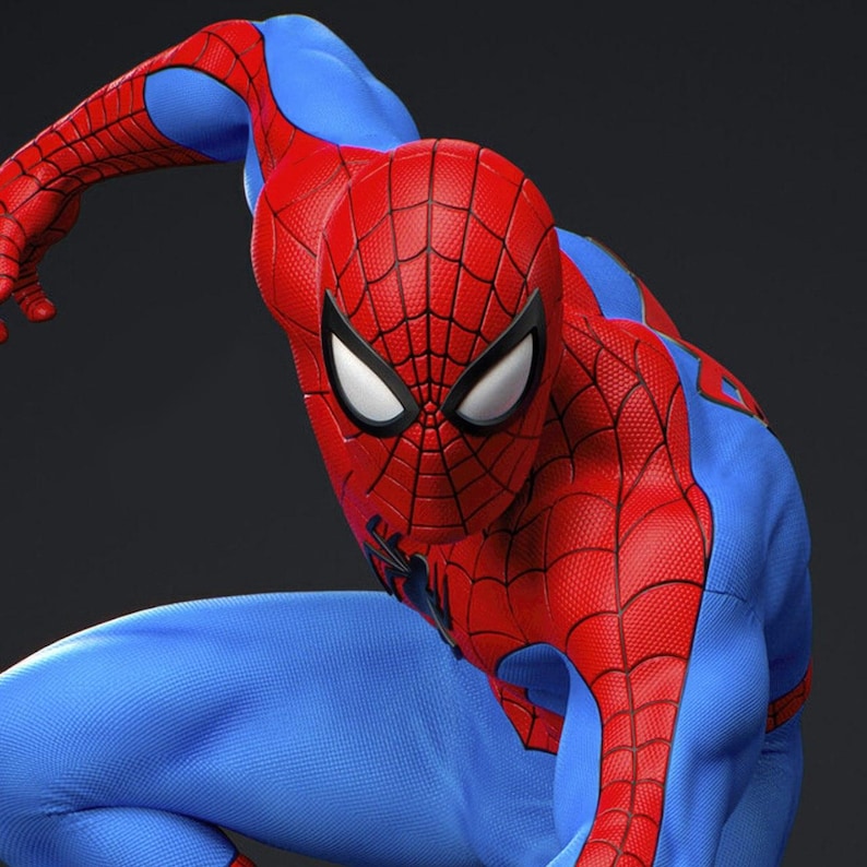 May include: A detailed image of a superhero in a red and blue costume. The costume features a red mask with white eye lenses and a web pattern. The superhero is in a crouching position, with a dark background.