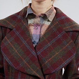 May include: A red, green, and blue plaid coat with a large collar. The coat is made of a soft, warm fabric and has a classic, timeless style.