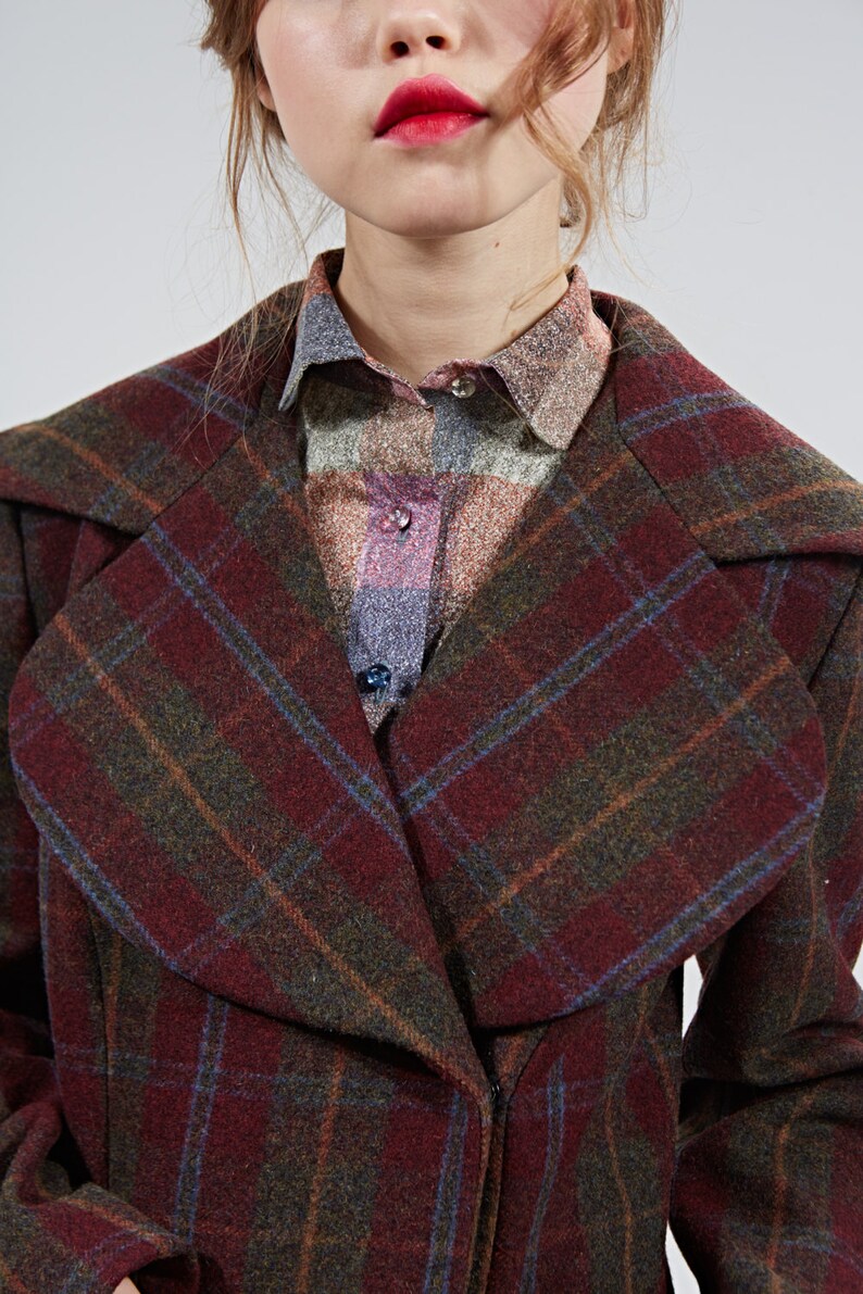May include: A red, green, and blue plaid coat with a large collar. The coat is made of a soft, warm fabric and has a classic, timeless style.