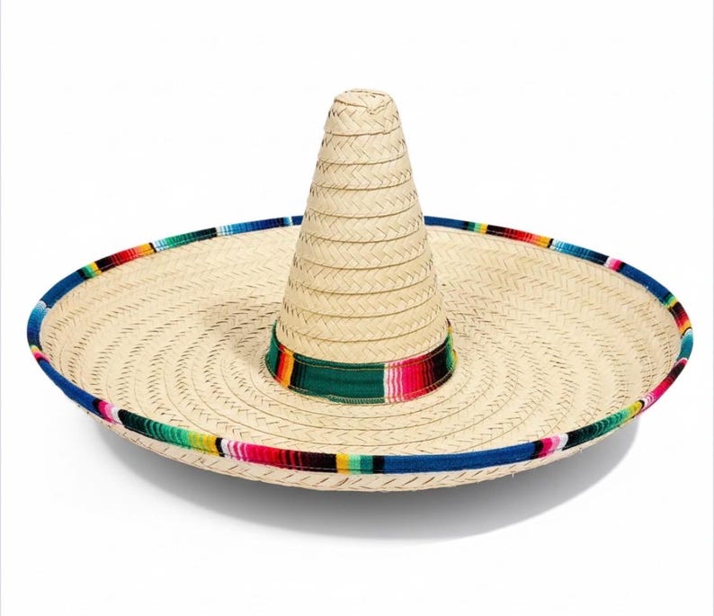 May include: A natural straw sombrero with a wide brim and a tall, conical crown. The brim is trimmed with a blue border and a colorful striped band. A green and striped band encircles the base of the crown.