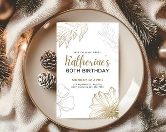 May include: A birthday invitation with gold and white floral design. The invitation reads "Katherine's 60th Birthday" with the date and RSVP information. The invitation is on a beige plate with pinecones and greenery.