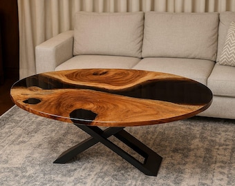 Mesa de centro ovalada de borde vivo: resina epoxi negra y patas de hierro en forma de X